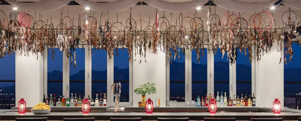 Bar top with lanterns on it, windows behind the bar with a view of the Arizona mountains.